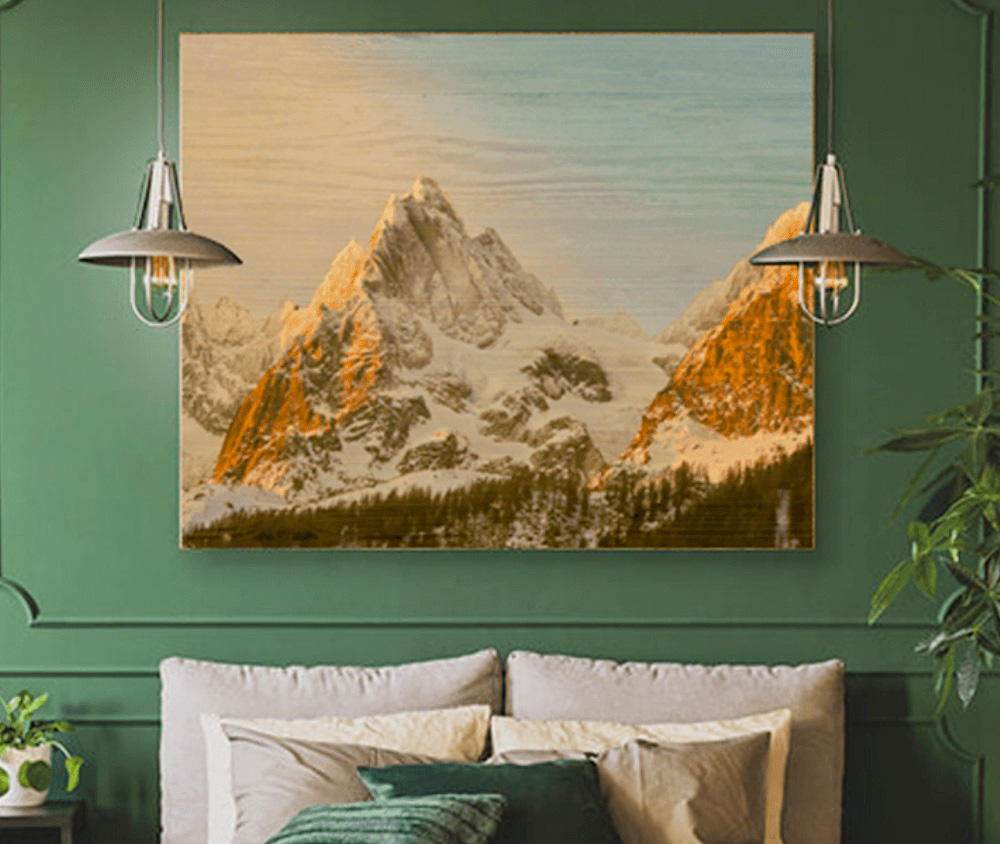 picture hanging on wall with lamps on either side and cushions below the picture