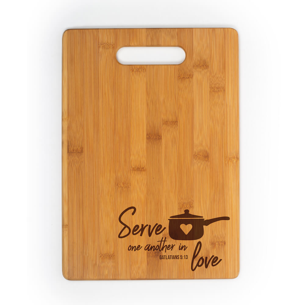 Rectangular cutting board with a handle engraved with Serve one another in love