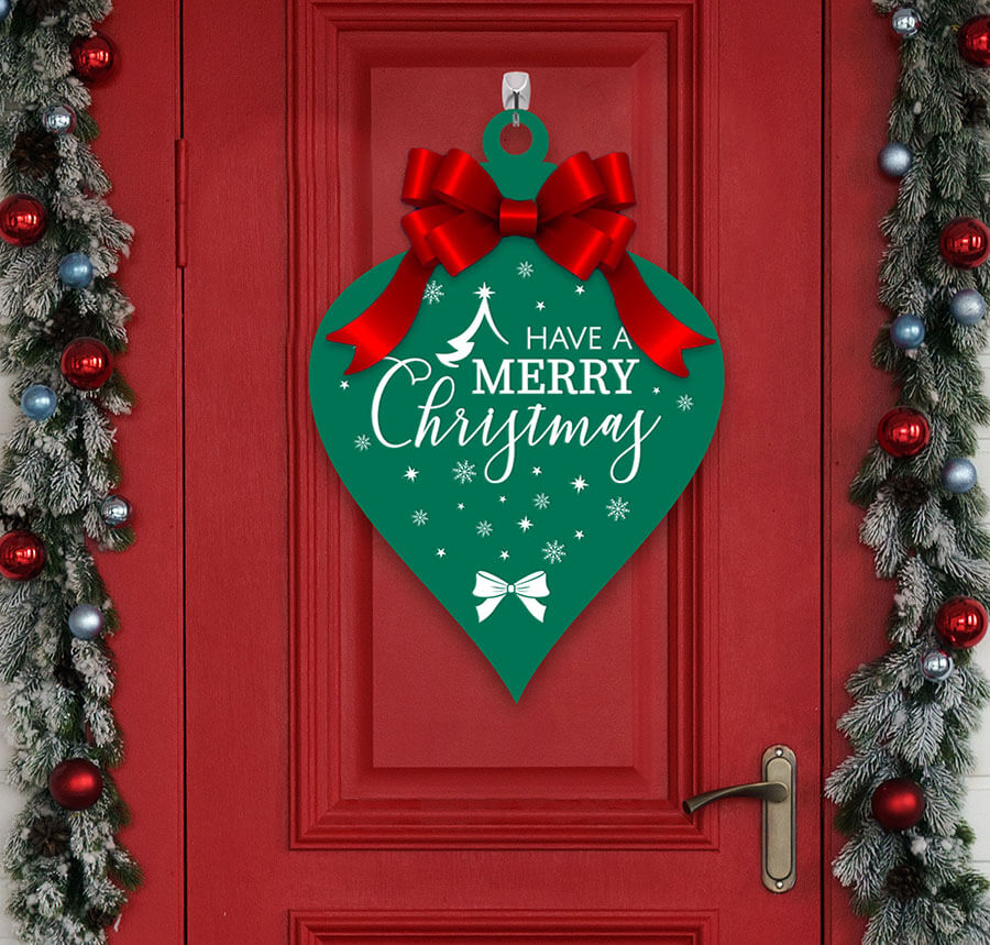 customized ornament shaped sign hanging on a decorated red door