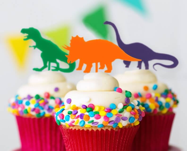 Cupcakes with dinosaur toppers stuck in each one