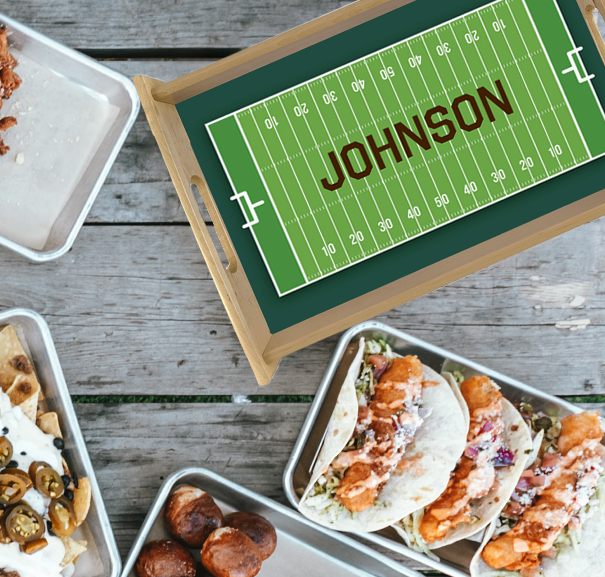 serving tray customized with a name and sports design set on a table near other trays of food