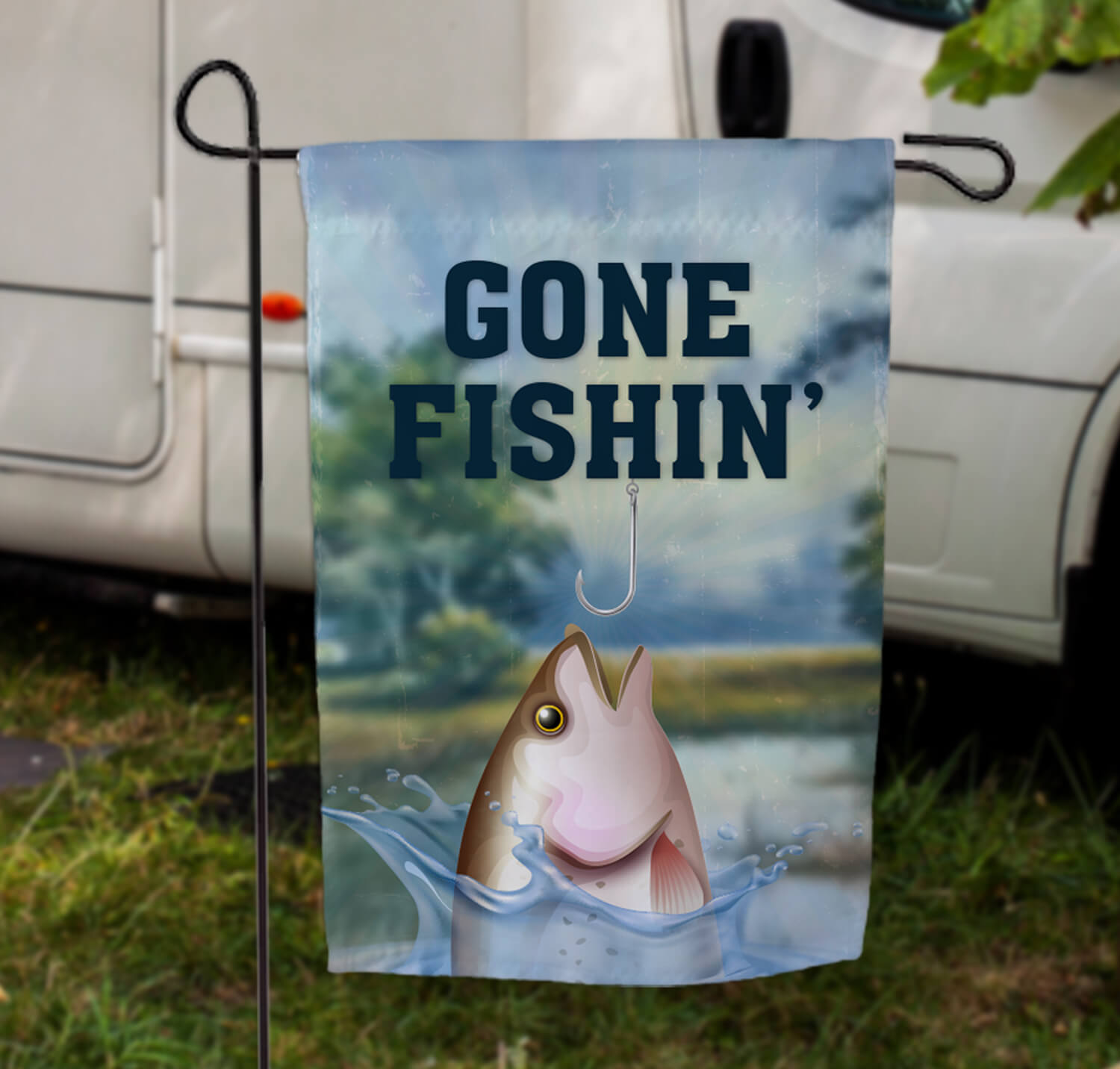 garden flag on display customized with 'gone fishin' and an image of a fish almost on a hook