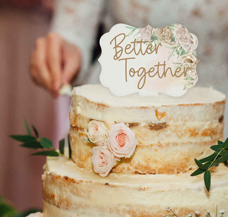 customized cake topper stuck in the top of a decorated cake