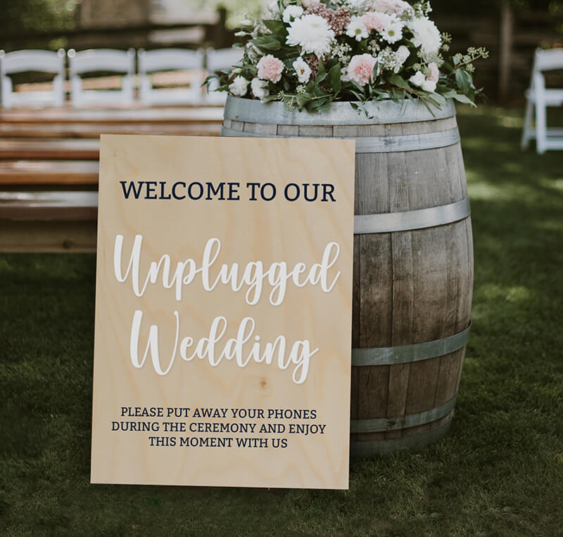 unplugged wedding sign asking guests to put away phones during the ceremony