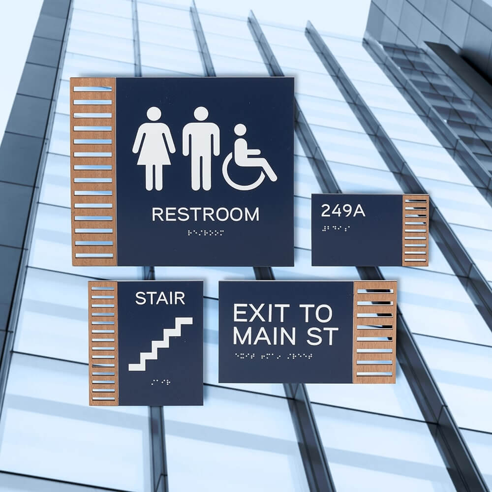 variety of wall mounted signs with Braille, symbols, and wording
