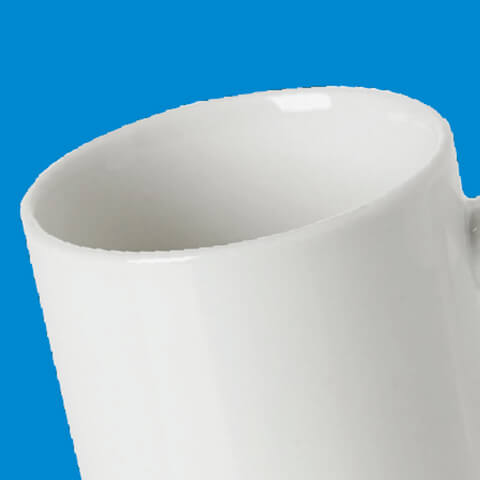 angled view of a white ceramic mug
